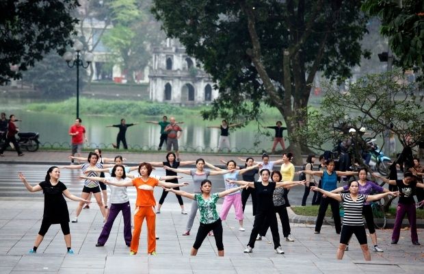 People doing exercises in Hoan Kiem Lake in the early morning